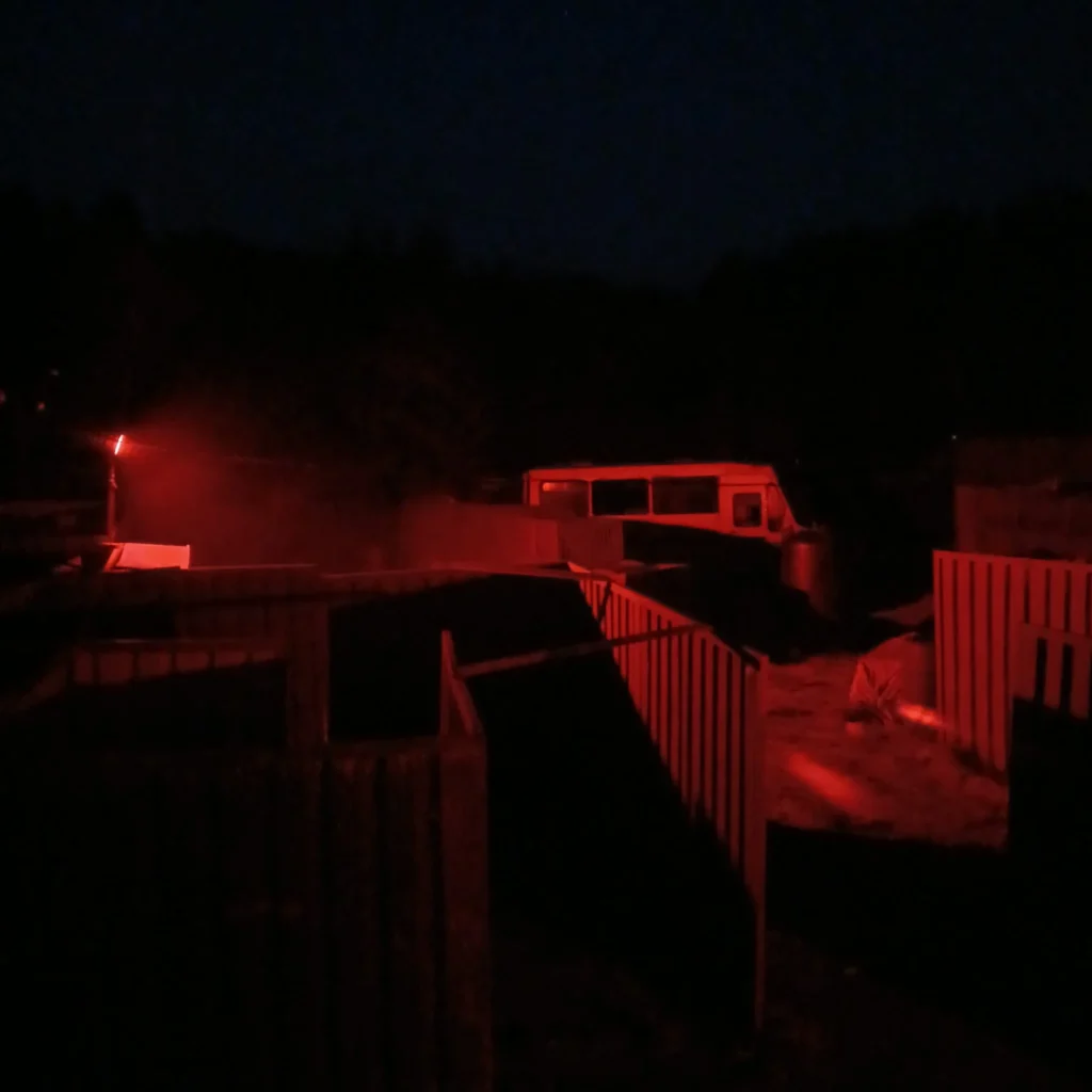CQB Airsoft Village at night with red ambient lighting
